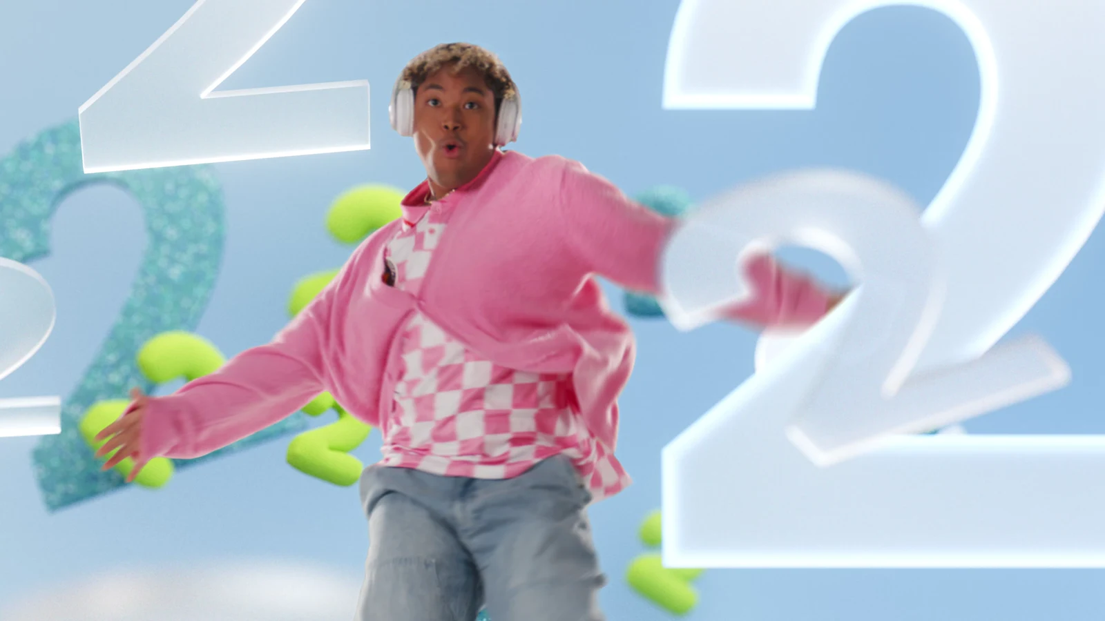 A dancer in pink among floating number twos