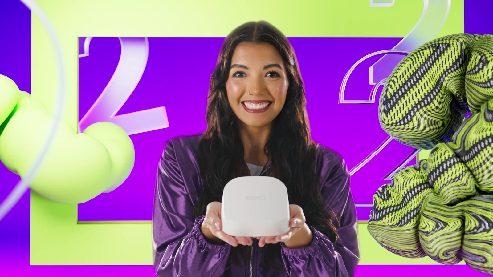 A woman holding an eero device against a colorful backdrop